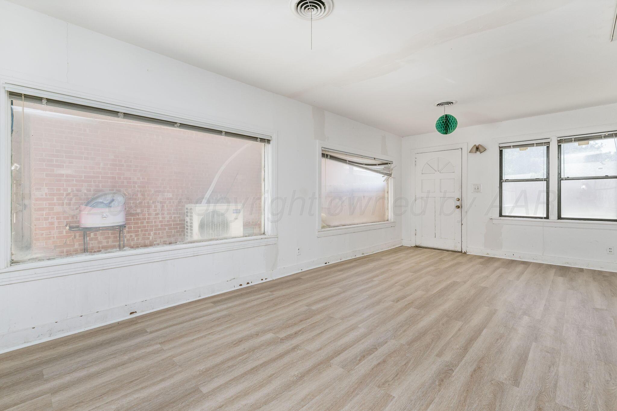 1018 South Bryan Street Amarillo, TX 79102 - Photo 23 of 41 an empty room with wooden floor and windows