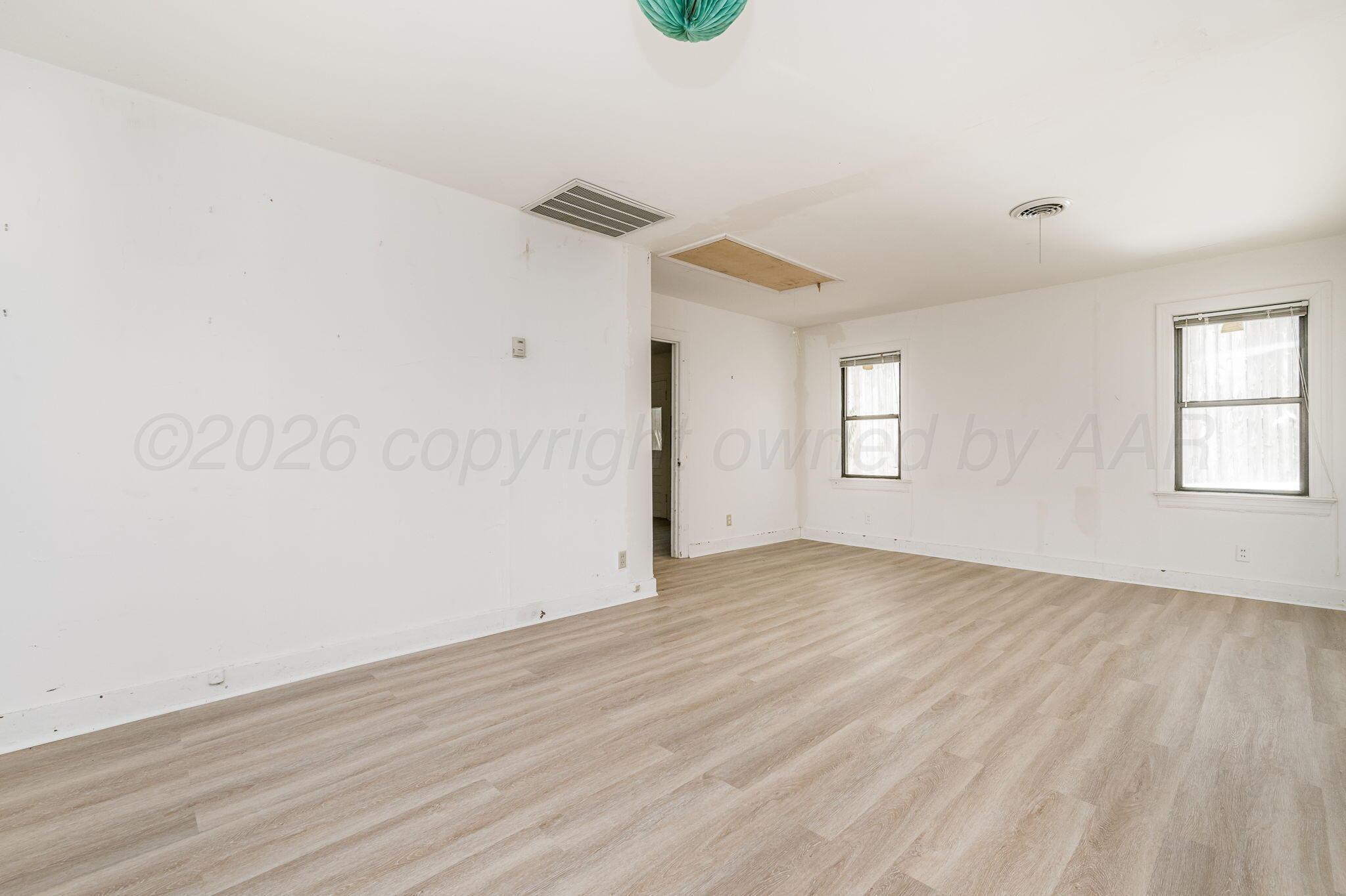 1018 South Bryan Street Amarillo, TX 79102 - Photo 24 of 41 an empty room with wooden floor and windows