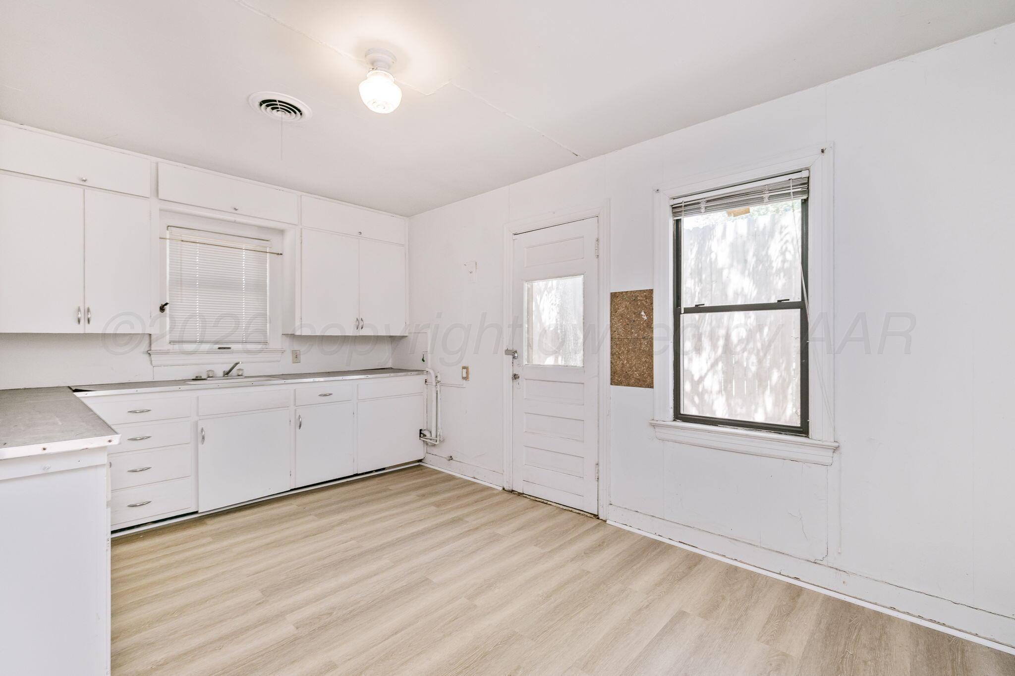 1018 South Bryan Street Amarillo, TX 79102 - Photo 26 of 41 a view of a kitchen with wooden floor and windows