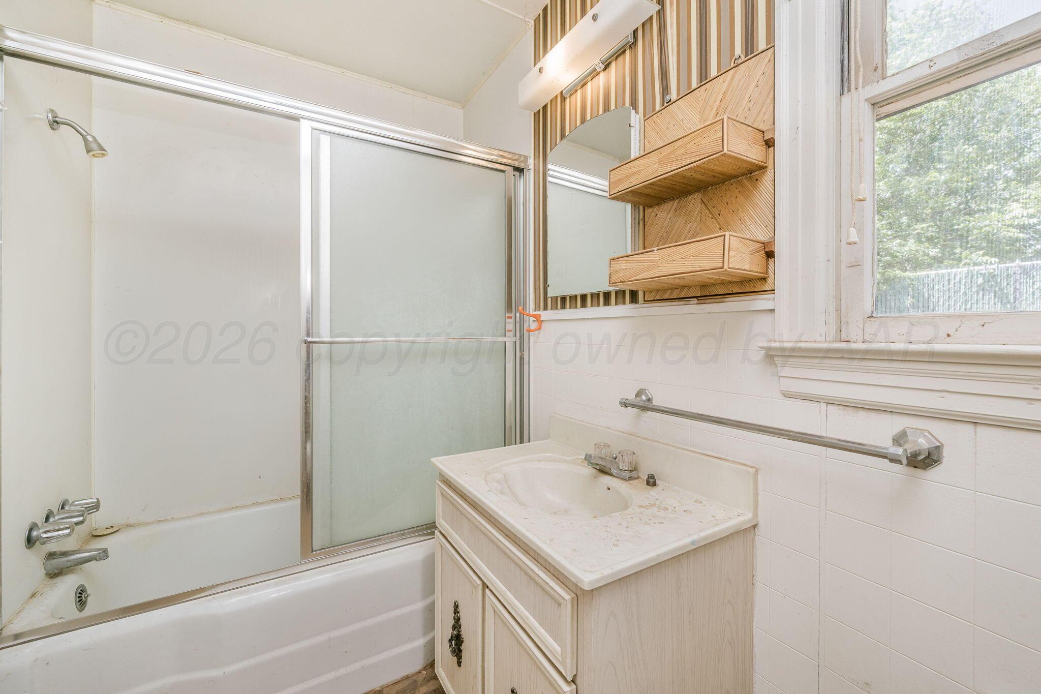 1018 South Bryan Street Amarillo, TX 79102 - Photo 28 of 41 a bathroom with a sink and a mirror