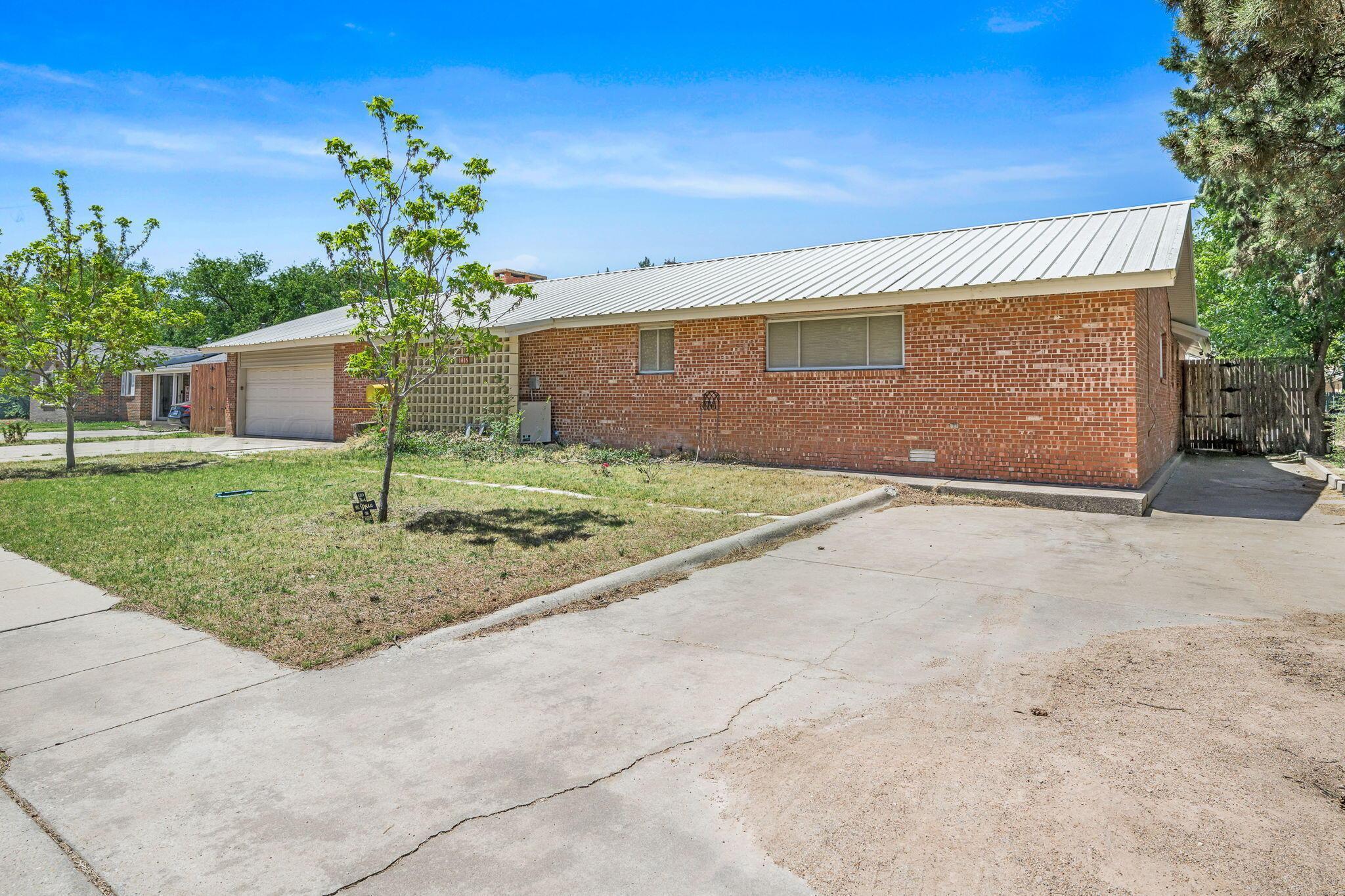 1018 South Bryan Street Amarillo, TX 79102 - Photo 30 of 41 a front view of a house with a yard