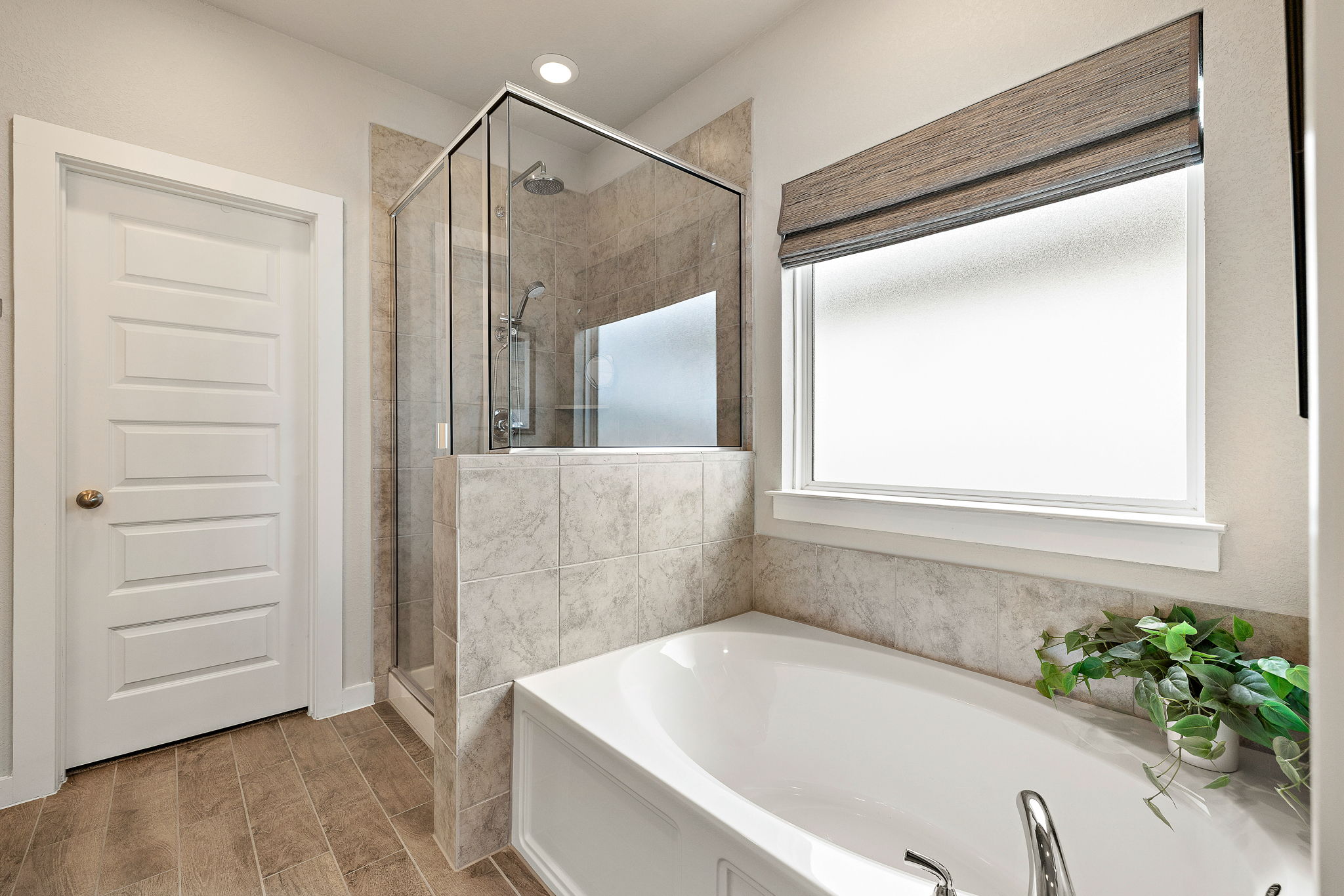 234 Appleberry Lane Elgin, TX 78621 - Photo 22 of 28 The ensuite has a soaking tub, separate shower, and window that brings in soft natural light, while keeping things private.