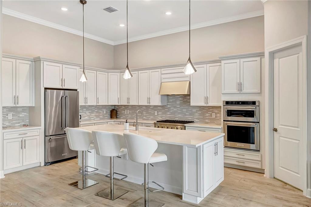 9574 Everglades Boulevard North Naples, FL 34120 - Photo 8 of 45 Kitchen with Island Seating and Walk-in Pantry