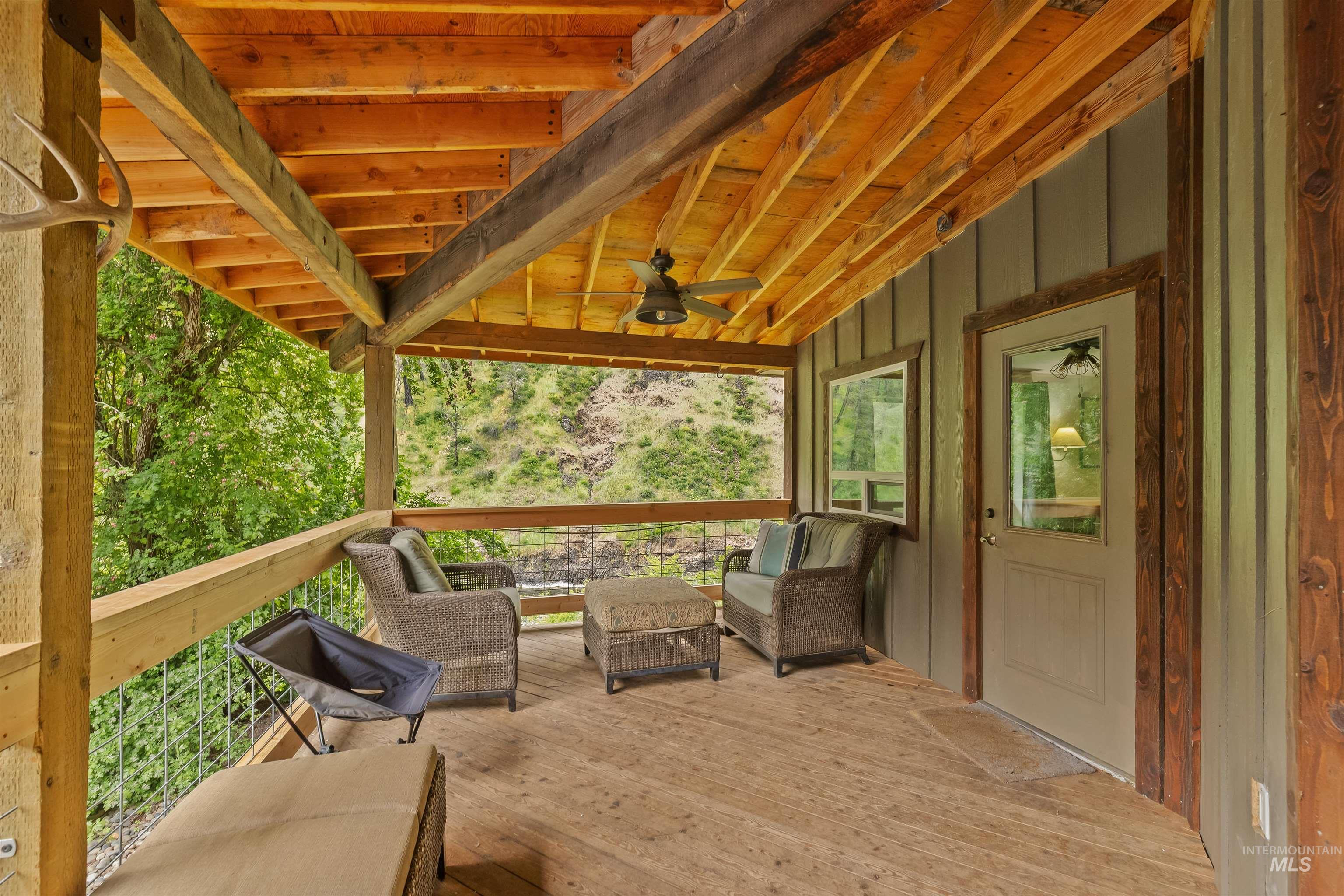 1314 Cedar Ridge Road Kendrick, ID 83537 - Photo 8 of 50 Covered outdoor deck with wood-finish flooring and exposed beam ceiling