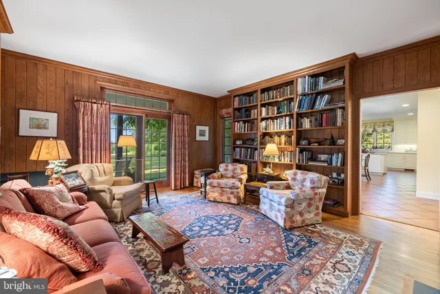 a dining room with furniture a chandelier and wooden floor