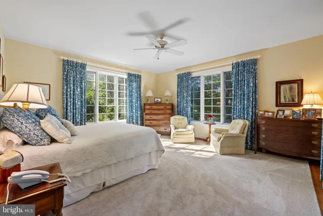 a living room with couch and a floor to ceiling window