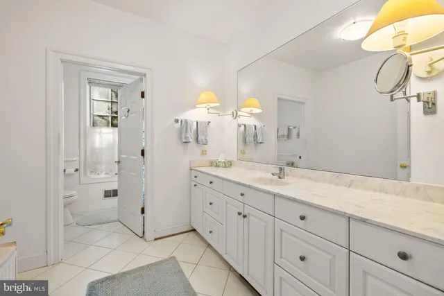 a view of balcony with two chairs and a potted plant