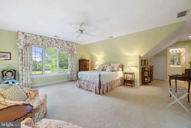 a view of a house with a big yard and palm trees