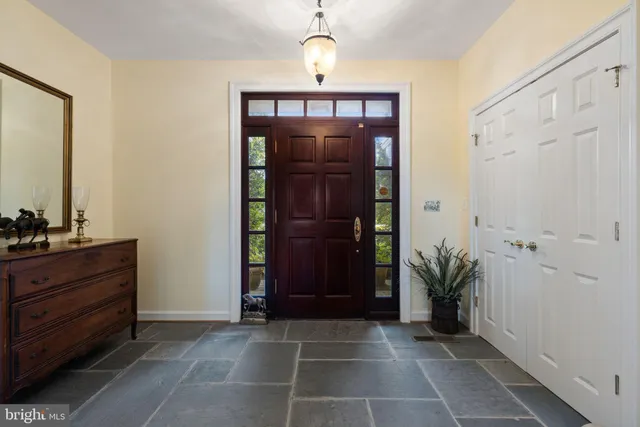 a living room with furniture large window and flat screen tv