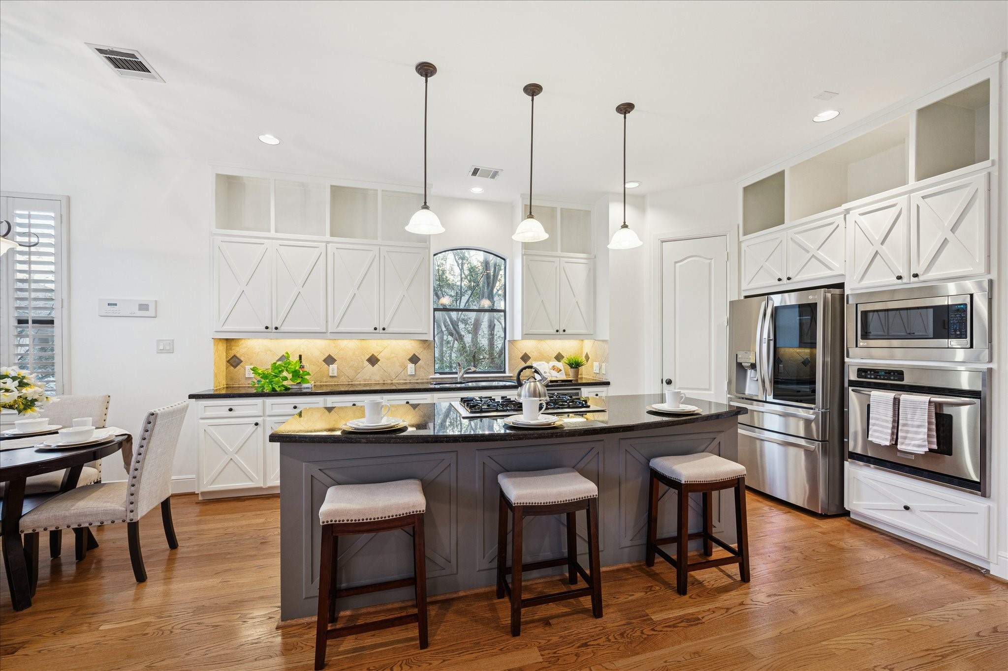 4226 Law Street, Unit B Houston, TX 77005 - Photo 14 of 32 a kitchen with stainless steel appliances granite countertop a sink a stove and chairs