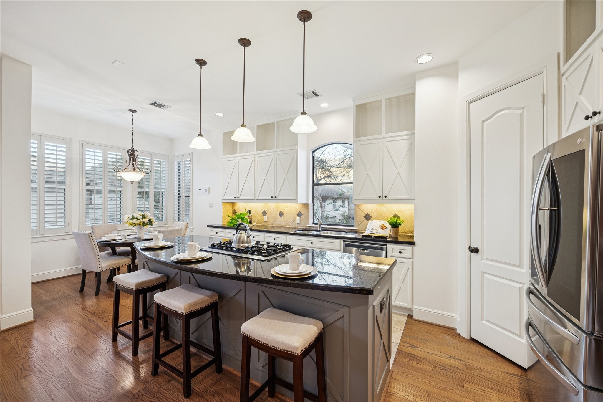 4226 Law Street, Unit B Houston, TX 77005 - Photo 18 of 32 a kitchen with stainless steel appliances granite countertop a stove a sink dishwasher a refrigerator white cabinets and wooden floor