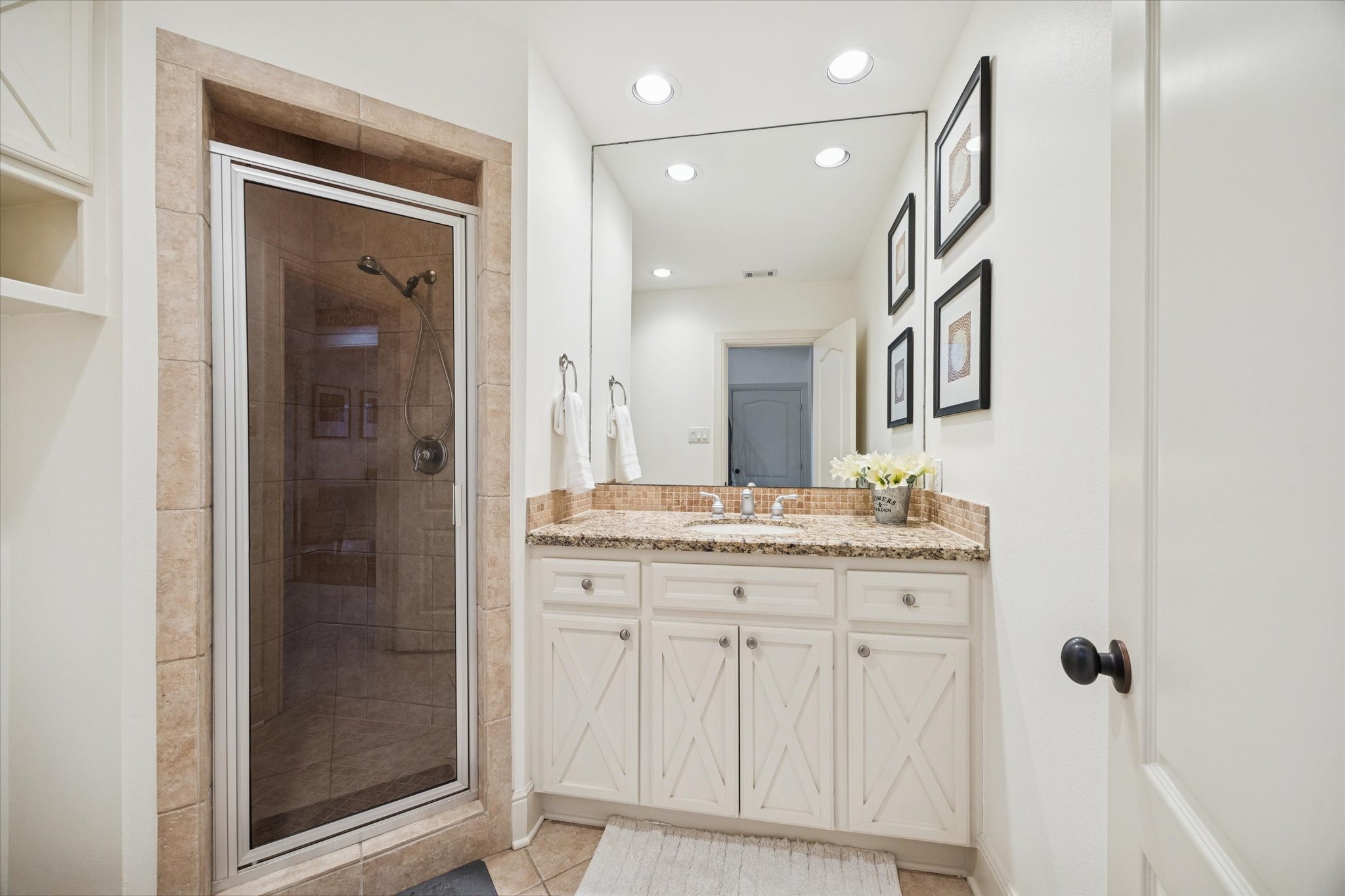 4226 Law Street, Unit B Houston, TX 77005 - Photo 8 of 32 a bathroom with a granite countertop sink a mirror and a shower