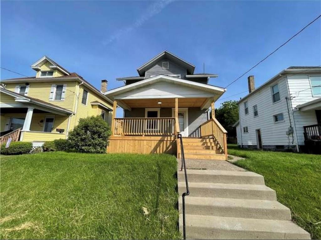1049 Adams Street New Castle, PA 16101 - Photo 1 of 10 a front view of a house with a yard
