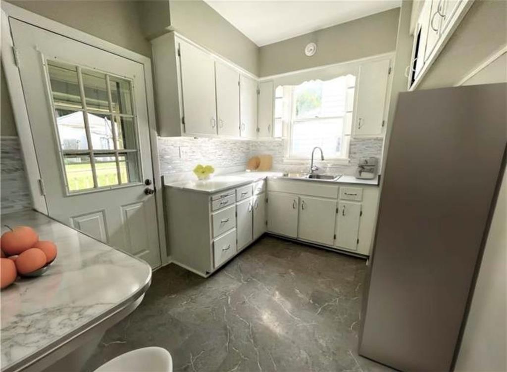 1049 Adams Street New Castle, PA 16101 - Photo 6 of 10 a kitchen with sink cabinets and window