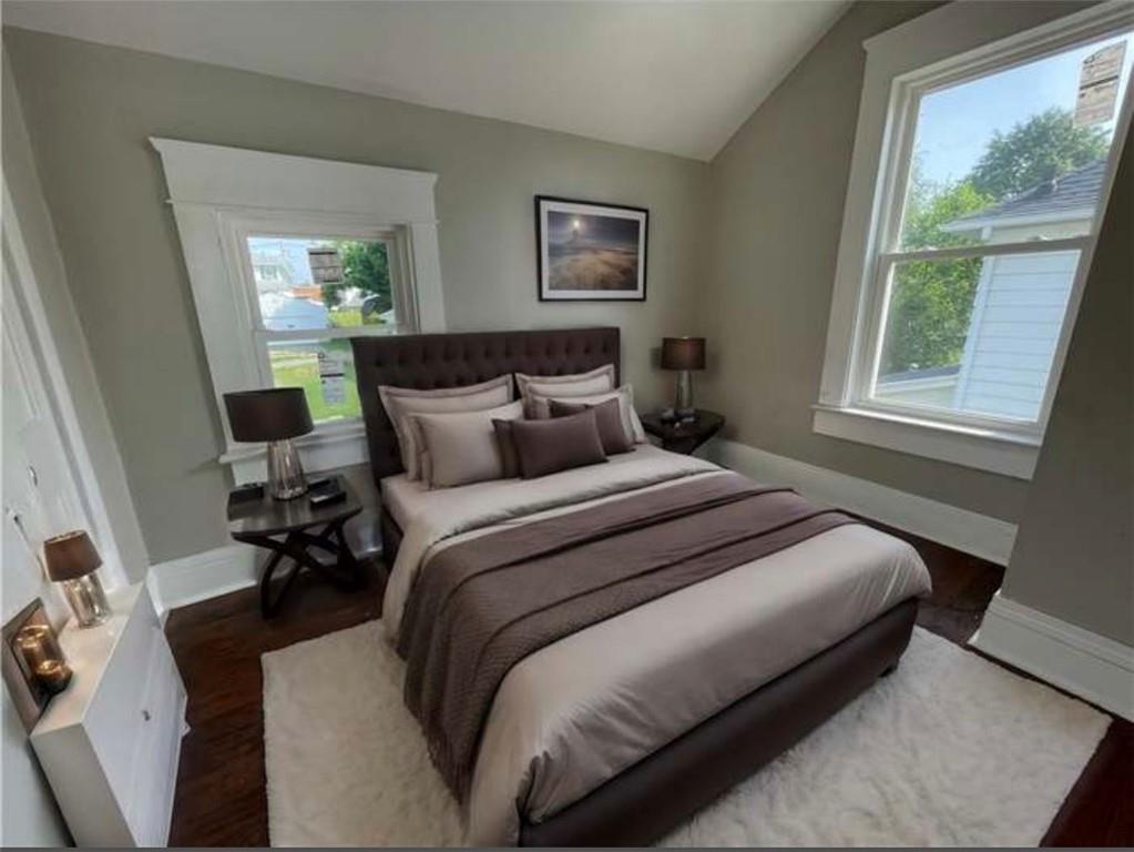 1049 Adams Street New Castle, PA 16101 - Photo 7 of 10 a bedroom with a bed a mirror and a window