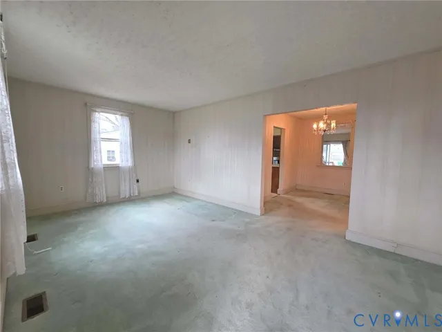 an empty room with windows and closet