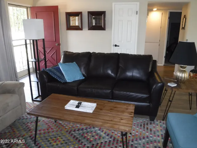 a living room with furniture rug and window