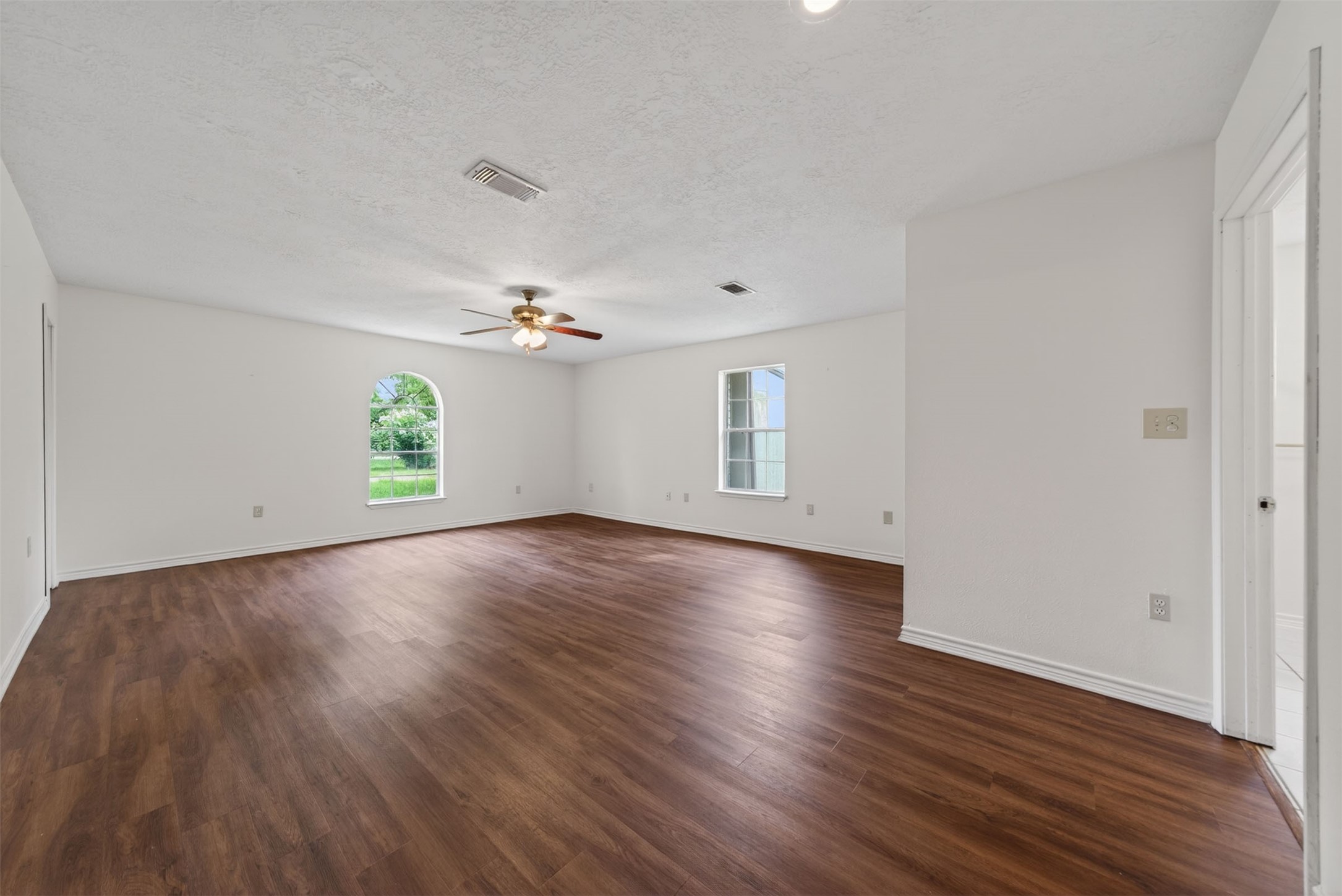 418 Texas Street Tomball, TX 77375 - Photo 7 of 31 This space features the primary bedroom. (Virtually staged/AI enhanced). Image does not represent actual property as is.