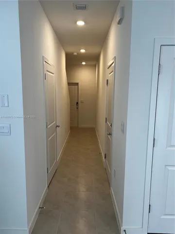 a large white kitchen with stainless steel appliances