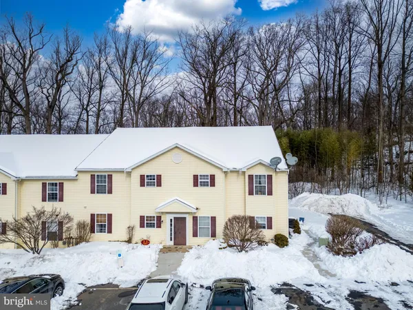 a view of a white house with a yard covered in snow