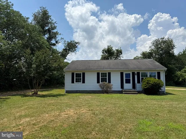 a house that has a tree in front of it