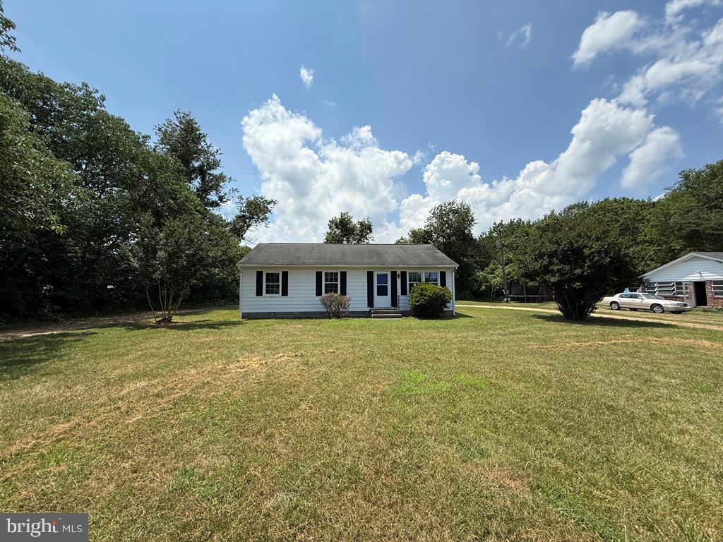 4282 Mary Ball Road Lancaster, VA 22503 - Photo 3 of 18 a front view of a house with a garden