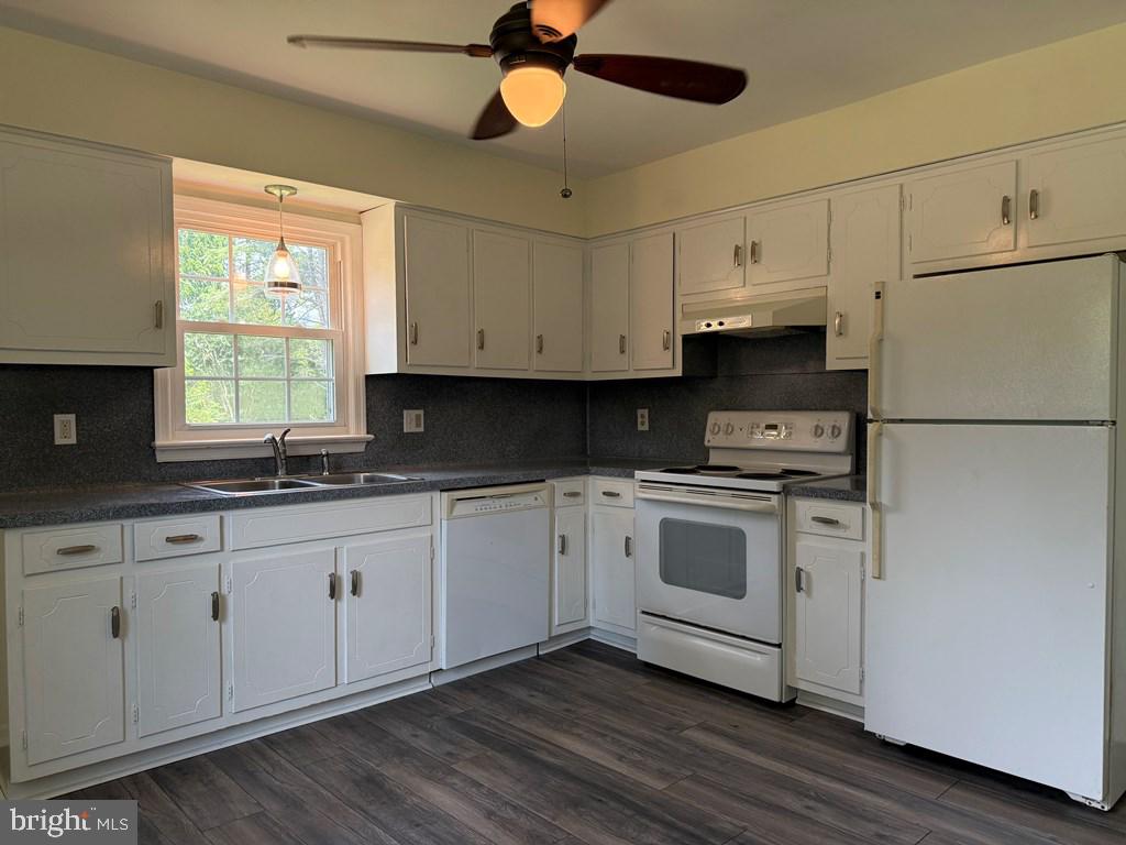 4282 Mary Ball Road Lancaster, VA 22503 - Photo 5 of 18 a kitchen with granite countertop white cabinets white appliances a sink and a window