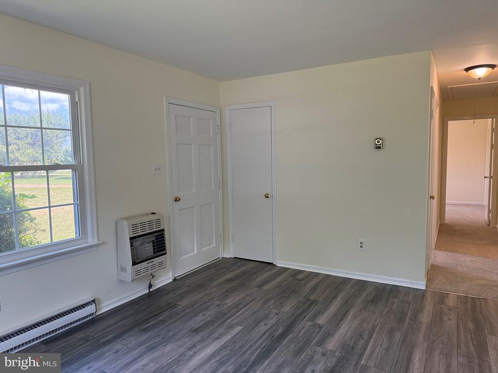 4282 Mary Ball Road Lancaster, VA 22503 - Photo 8 of 18 an empty room with wooden floor cabinet and windows