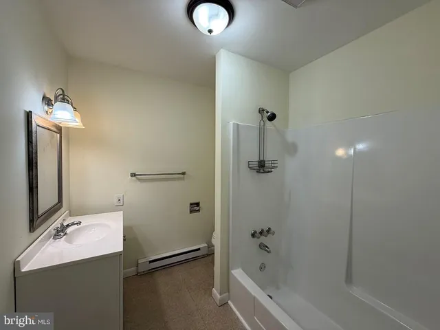 a bathroom with a tub and shower