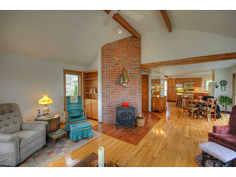 27 Kickapoo Run Charlestown, RI 02813 - Photo 5 of 20 Living Room. Gleaming hardwood floors accent the open living area. The Jotul wood stove supplements the baseboard oil heat.
