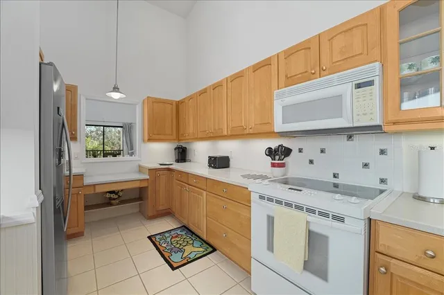 a kitchen with granite countertop cabinets and white appliances
