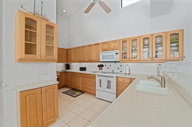 a kitchen with granite countertop a sink and cabinets