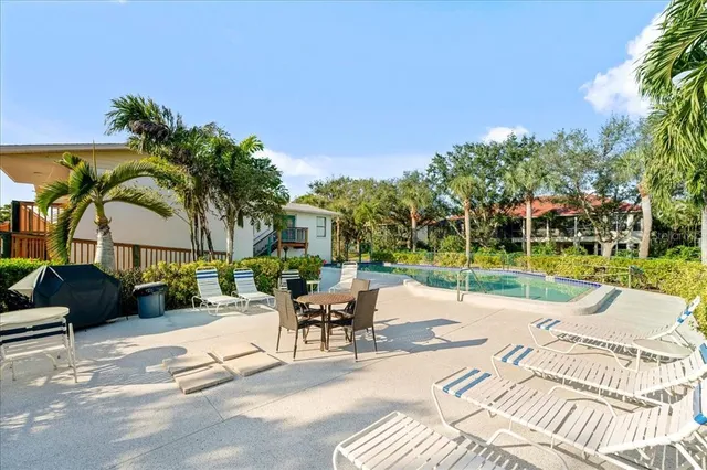 an aerial view of ocean and residential houses with outdoor space