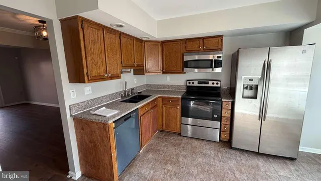 a kitchen with a refrigerator stove and microwave