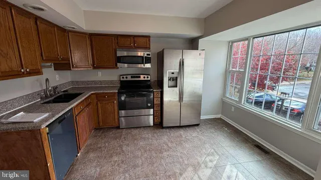 a kitchen with a refrigerator and a sink