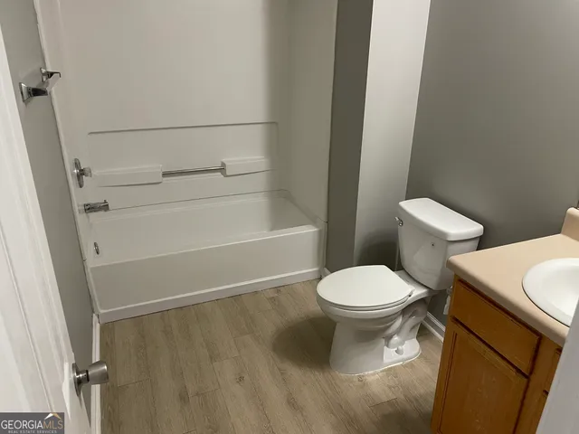a white toilet sitting next to a bathroom sink