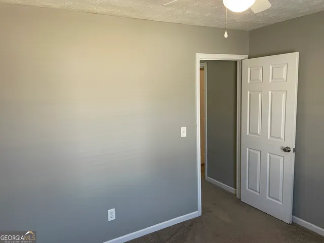 an empty room with closet area