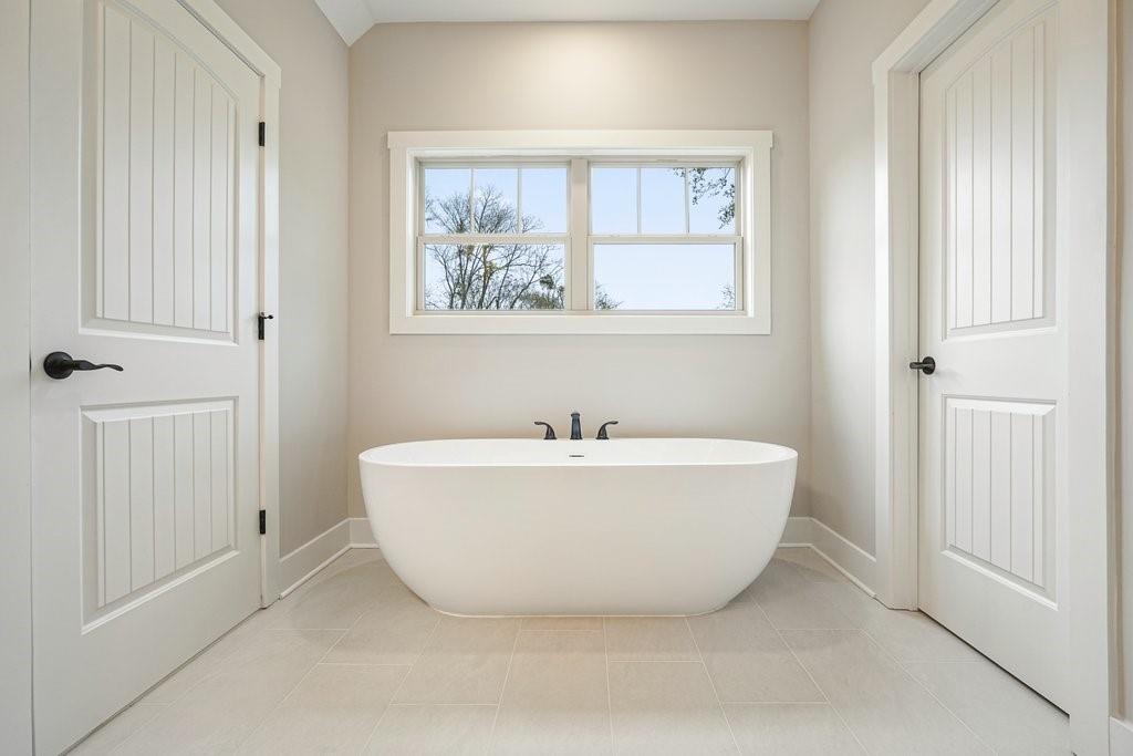 4749 Fowler Street Acworth, GA 30101 - Photo 23 of 60 a white bath tub sitting in a bathroom next to a window