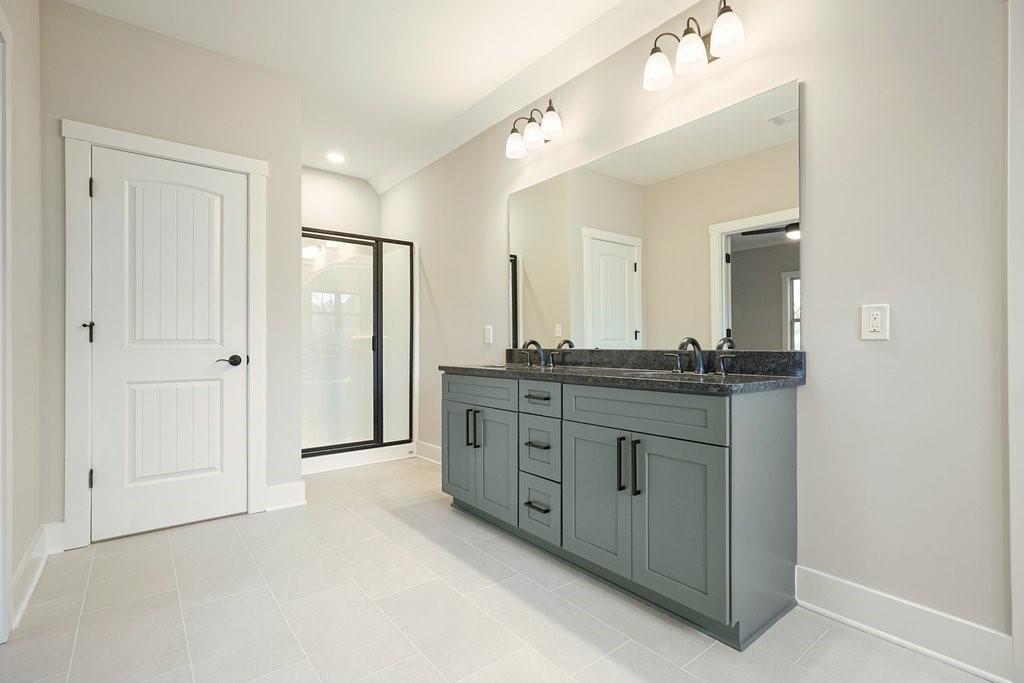 4749 Fowler Street Acworth, GA 30101 - Photo 24 of 60 a bathroom with a granite countertop sink mirror and shower