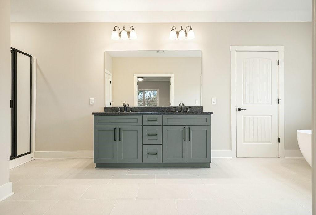 4749 Fowler Street Acworth, GA 30101 - Photo 25 of 60 a spacious bathroom with a sink and a mirror