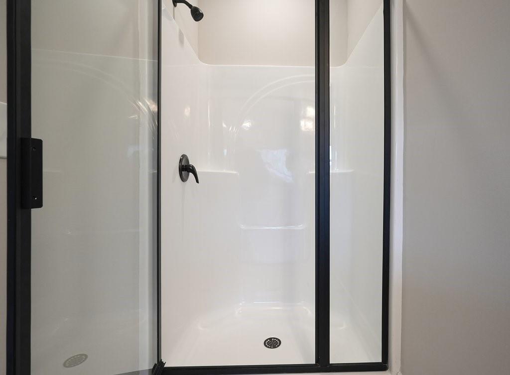 4749 Fowler Street Acworth, GA 30101 - Photo 27 of 60 a bathroom with a glass shower door