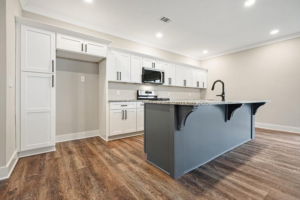 4749 Fowler Street Acworth, GA 30101 - Photo 9 of 60 a kitchen with kitchen island a sink stainless steel appliances and cabinets