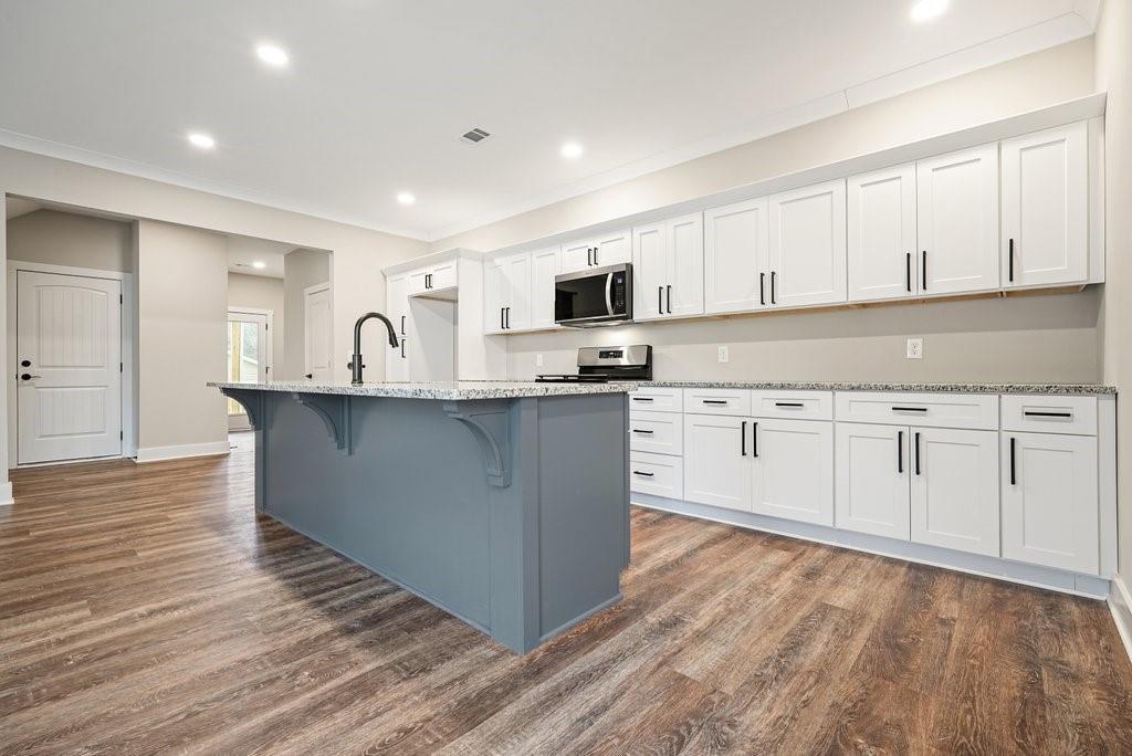 4749 Fowler Street Acworth, GA 30101 - Photo 10 of 60 a kitchen with stainless steel appliances granite countertop a sink a stove and cabinets