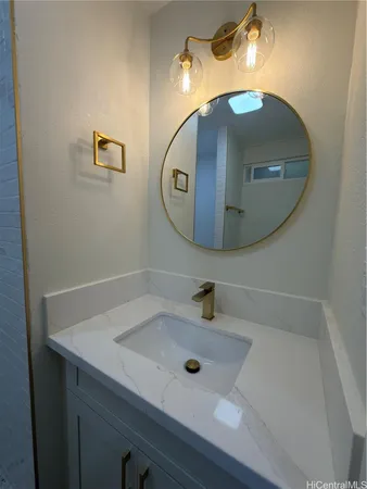 a bathroom with a sink and mirror