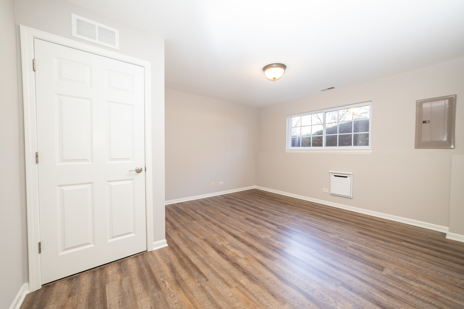 4313 Timber Ridge Court Joliet, IL 60431 - Photo 16 of 25 an empty room with wooden floor and windows