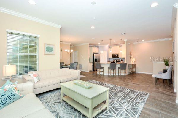 4212 Expedition Way Osprey, FL 34229 - Photo 8 of 28 a living room with furniture and a table