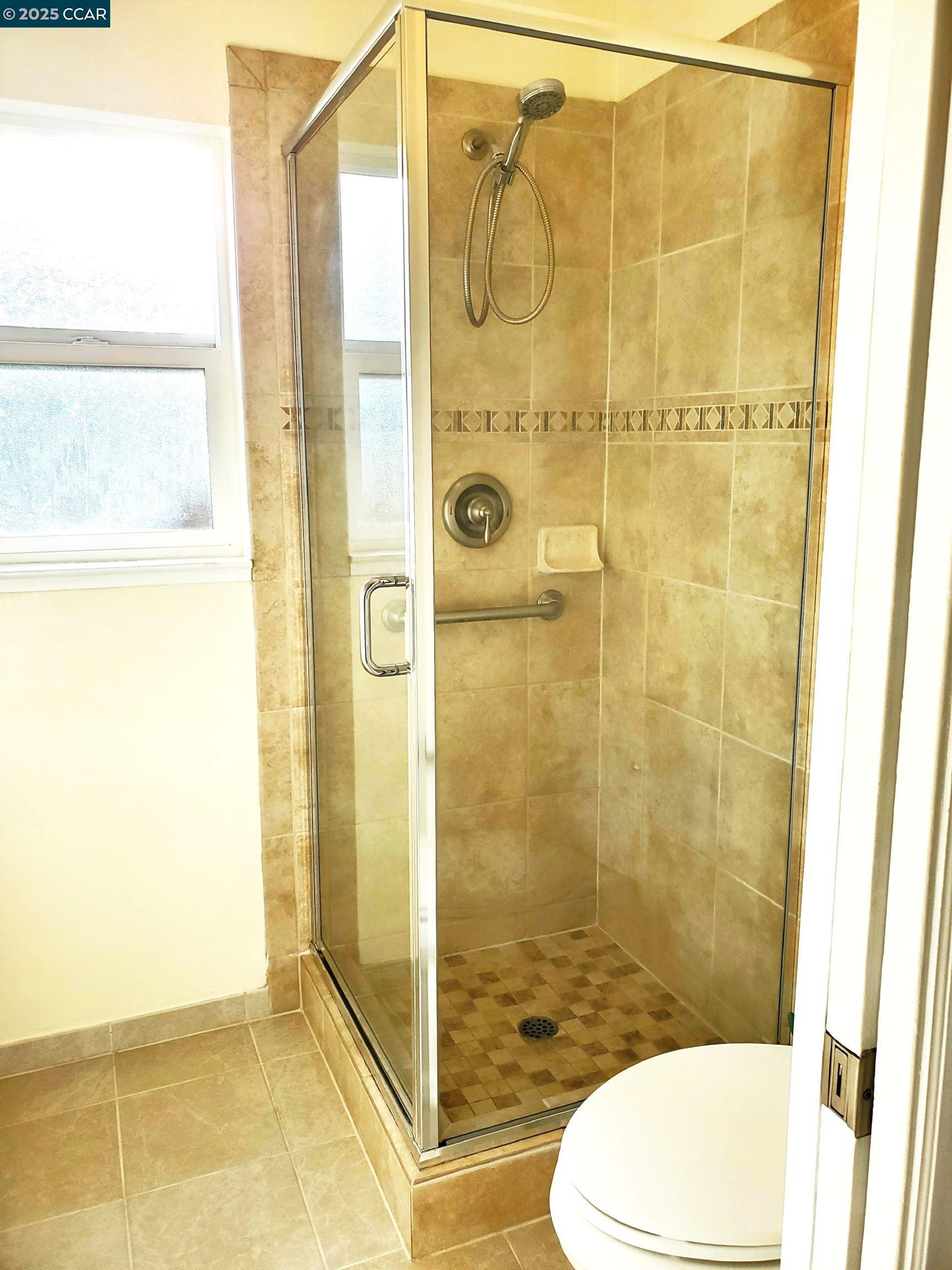 1616 Eve Drive Concord, CA 94521 - Photo 13 of 28 a bathroom with a shower and toilet