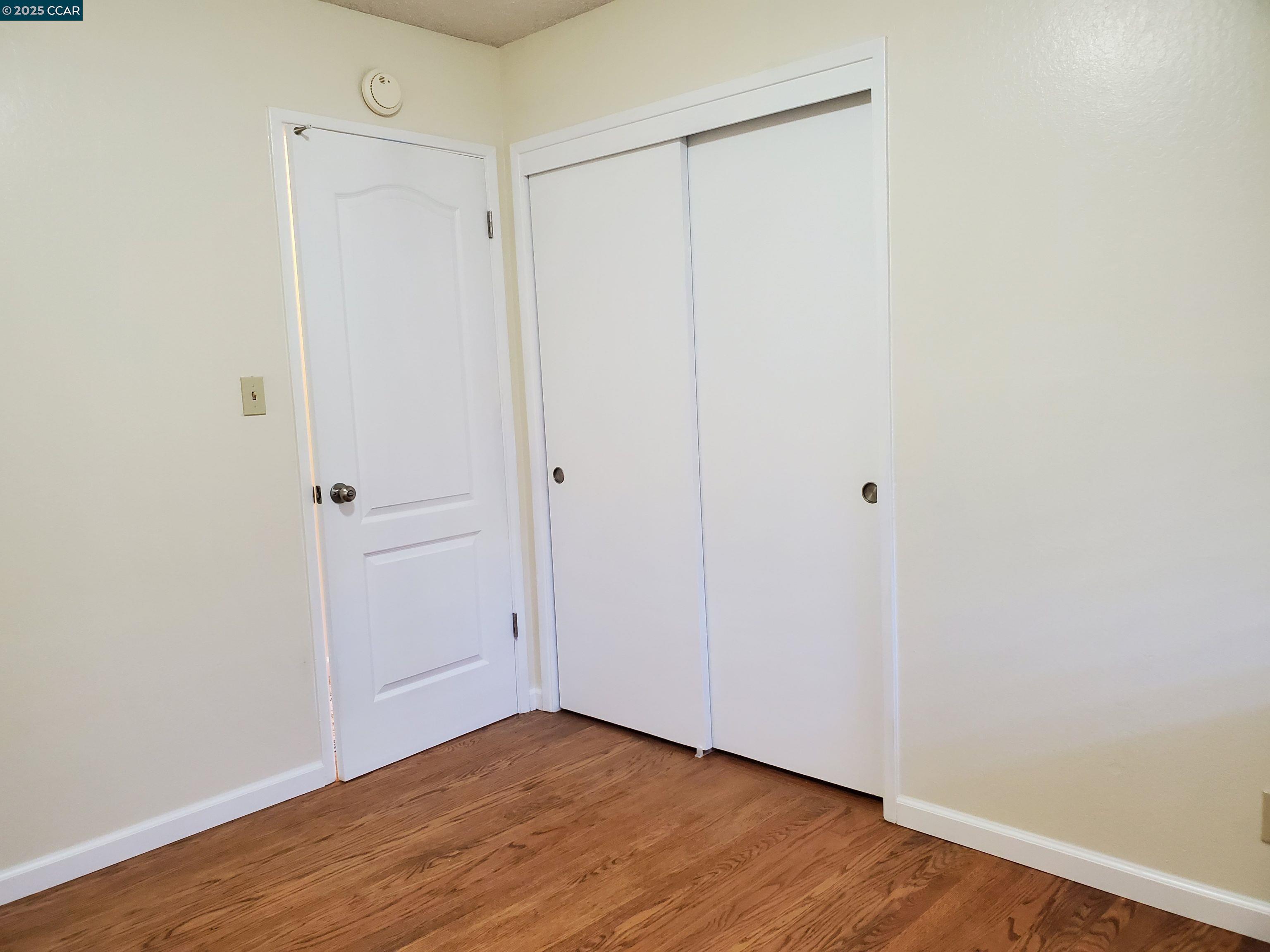 1616 Eve Drive Concord, CA 94521 - Photo 15 of 28 a view of an empty room with wooden floor