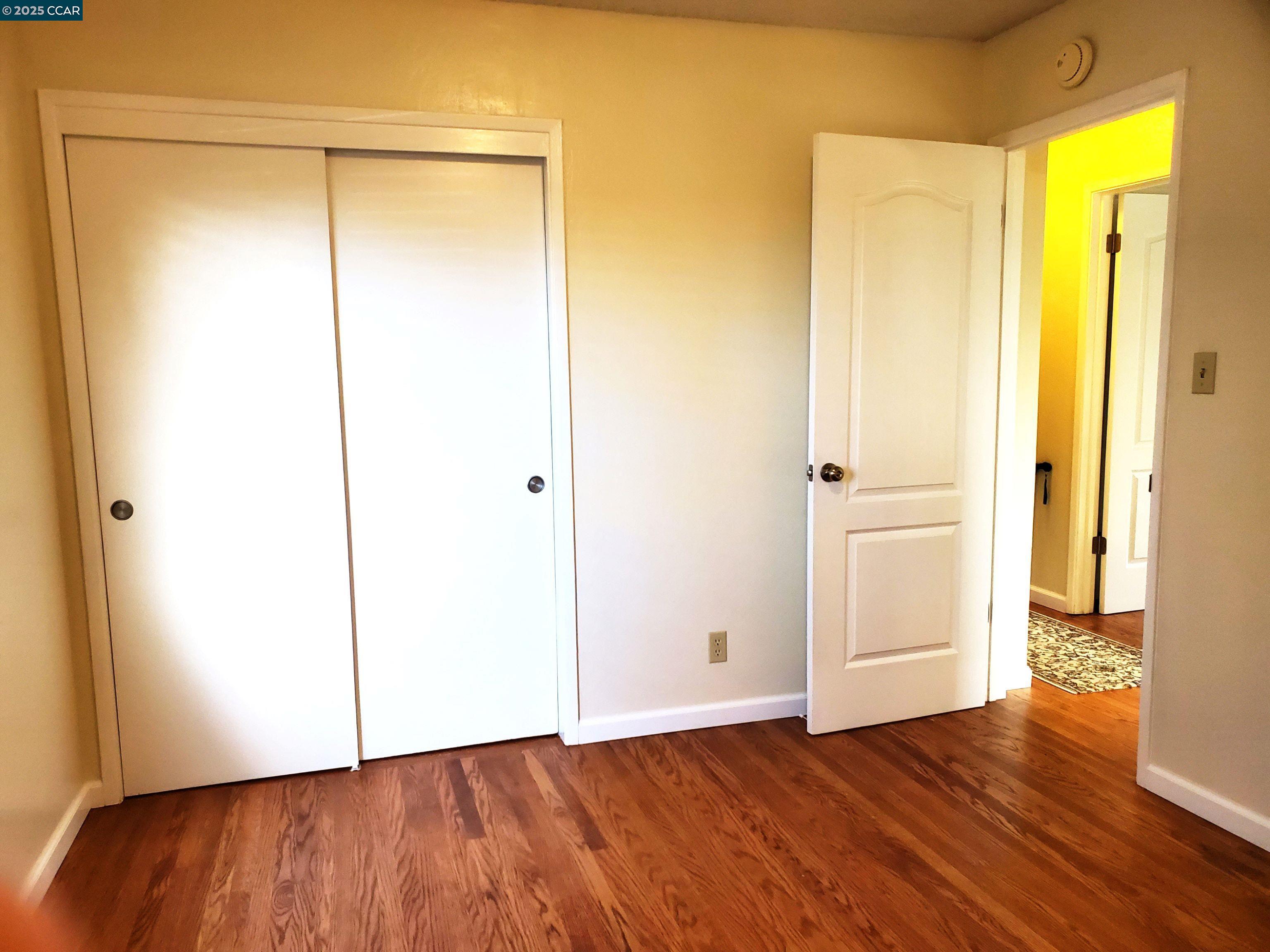1616 Eve Drive Concord, CA 94521 - Photo 18 of 28 a view of an empty room with wooden floor and a window