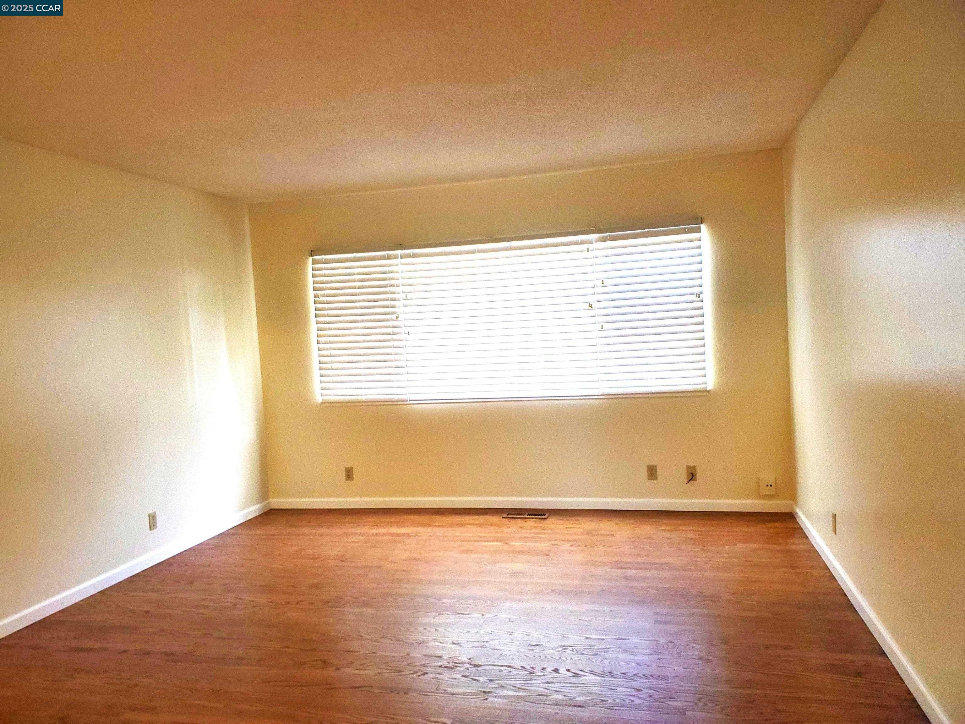 1616 Eve Drive Concord, CA 94521 - Photo 19 of 28 an empty room with wooden floor and windows